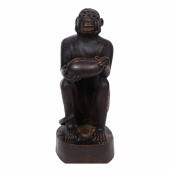 A CARVED MONKEY SEATED WITH CO