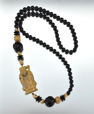 A Carved Netsuke and Onyx Bead