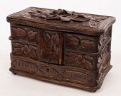 A carved oak jewel box with fi