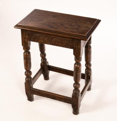 A carved oak joint stool, on