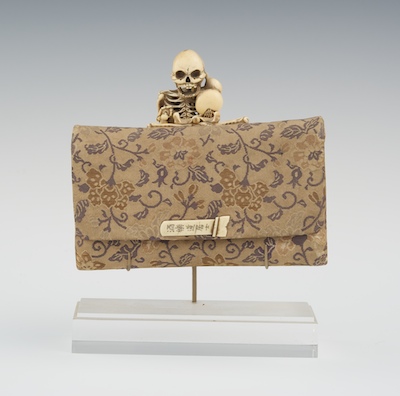 A Carved Skeleton Mounted Tobacco