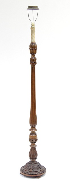 A carved standard lamp on a