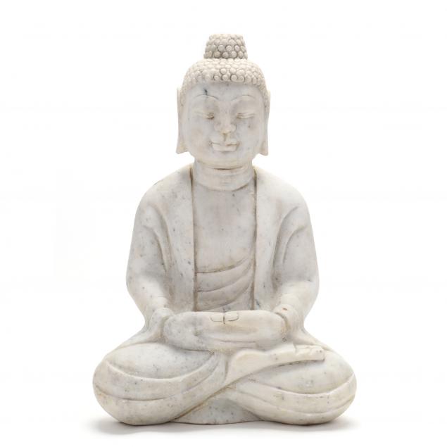 A CARVED STONE BUDDHA Carved in the
