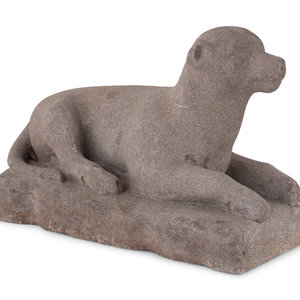 A Carved Stone Recumbent Dog, In