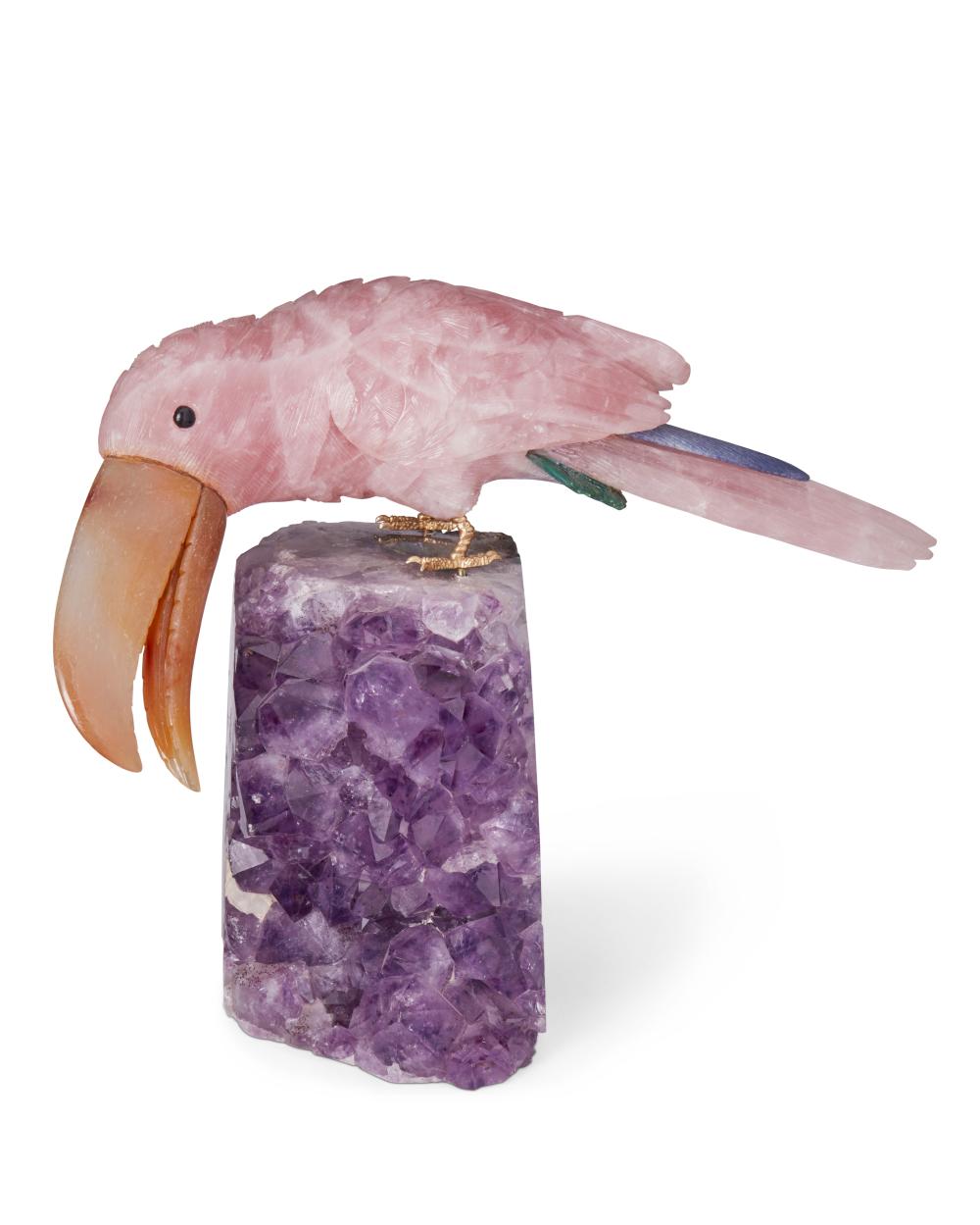 A CARVED STONE TOUCAN FIGURE AND