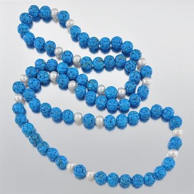 A Carved Turquoise Bead and Pearl
