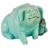 A CARVED TURQUOISE FIGURE OF A