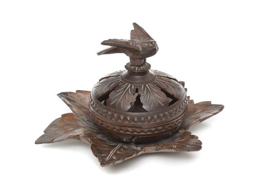 A Carved Walnut Box having a bird