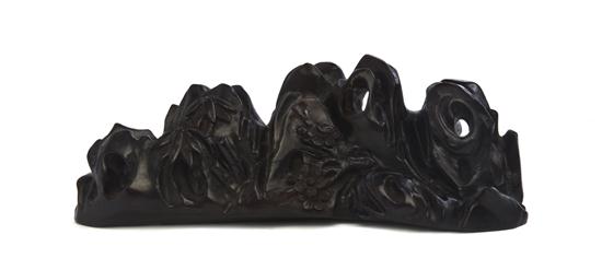 A Carved Wood Brushrest depicting a