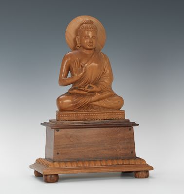 A Carved Wood Buddha Figurine on