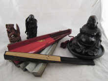 A carved wood Buddha with metal