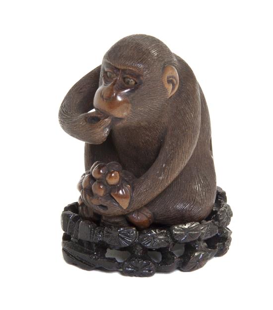 A Carved Wood Netsuke depicting a