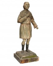 A CARVED WOOD SANTOS FIGUREA c