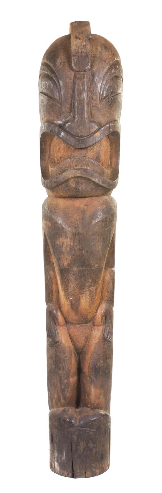 A Carved Wood Tiki depicted upright