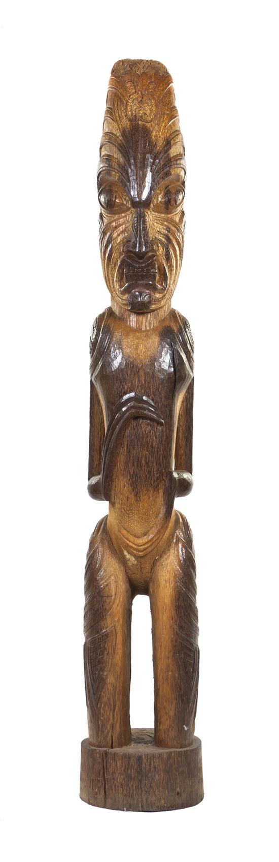 A Carved Wood Tiki depicting a