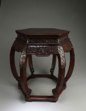 A CARVED WOODEN HEXAGONAL SHAP