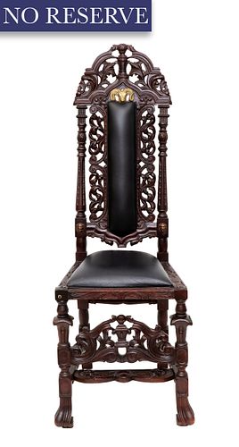 A CARVED WOODEN HIGHBACK CHAIR WITH
