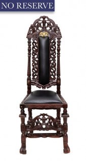 A CARVED WOODEN HIGHBACK CHAIR