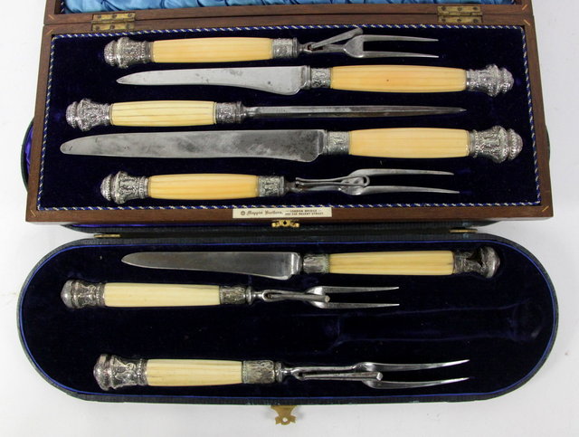 A carving knife and two forks