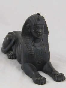 A cast bronze model of sphynx.