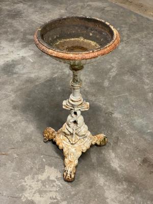 A cast iron bird bath with