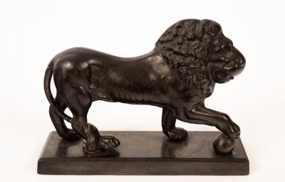 A cast iron figure of a lion,