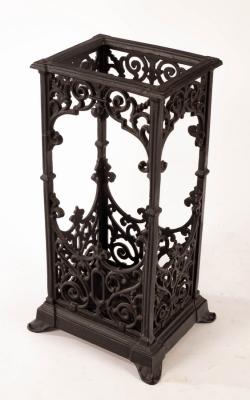 A cast iron stick stand, pierced