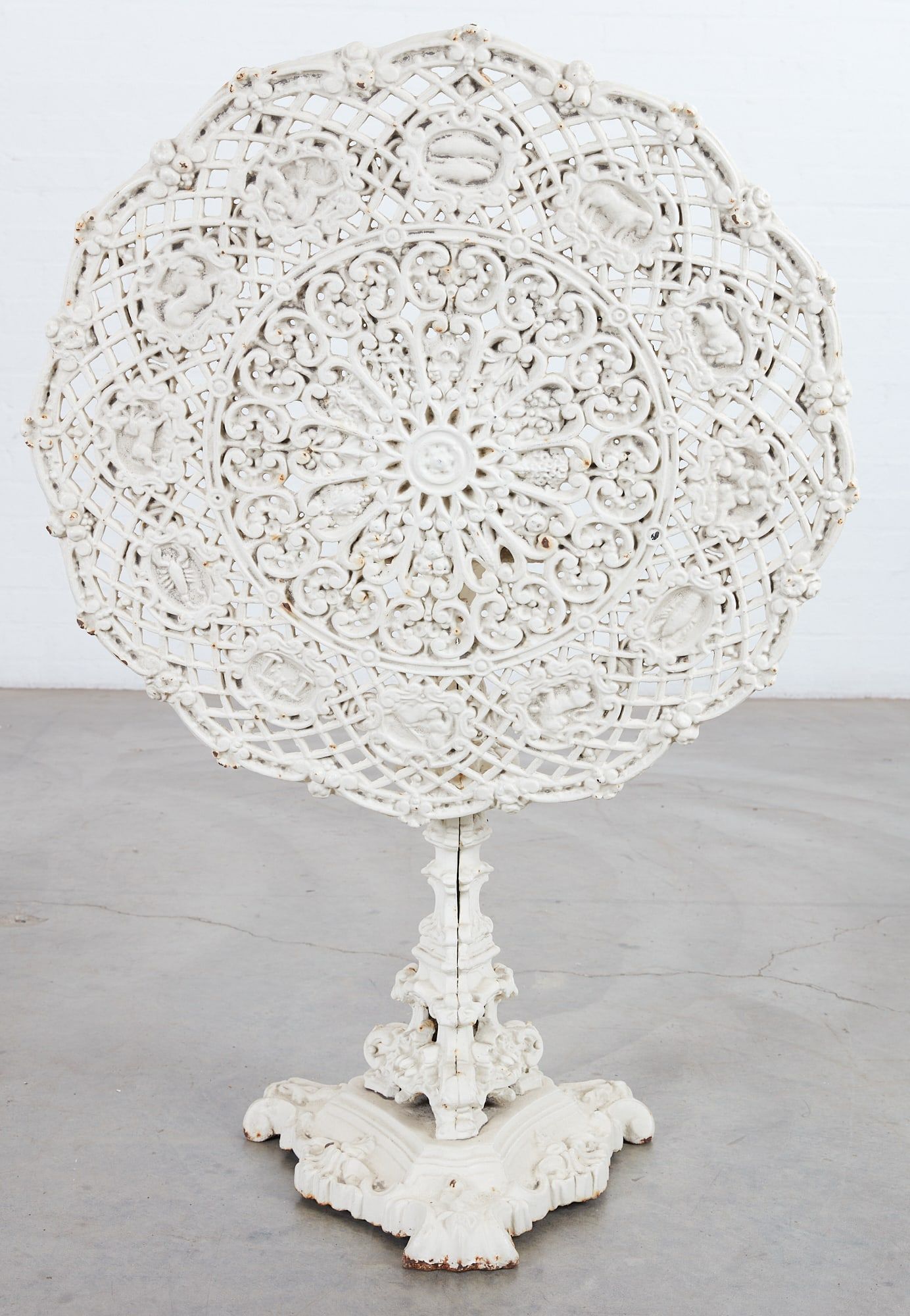 A CAST IRON TILT TOP ZODIAC