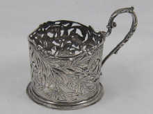 A cast silver tea glass holder with