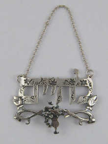 A cast silver wine label with