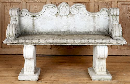 A CAST STONE GARDEN BENCH RAISED ON