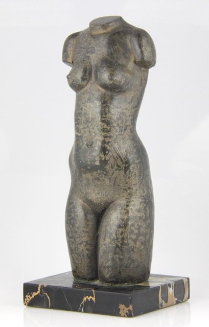 A cast torso of a nude circa