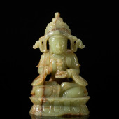 A CAVED GREEN JADE SEATED FIGU