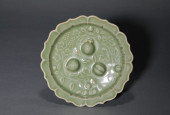 A CELADON-GLAZED 'THREE ABUNDA