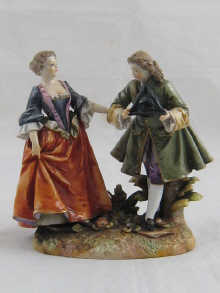 A ceramic group of a lady and a