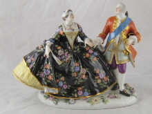 A ceramic group of a lady and