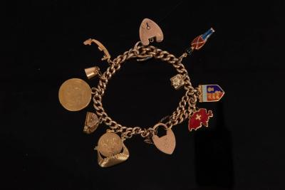 A charm bracelet, the 9ct curb-link