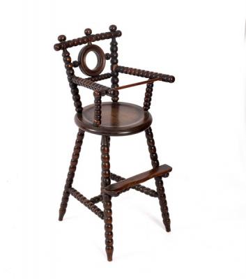 A child's high chair in beech