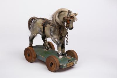 A child's toy horse on wheels,