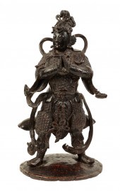 A CHINESE BRONZE STANDING FIGU