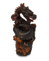 A CHINESE CARVED AMBER FIGURE