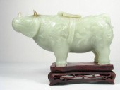 A Chinese carved green jade rh
