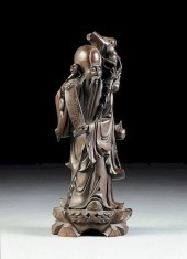A CHINESE CARVED HARDWOOD FIGU