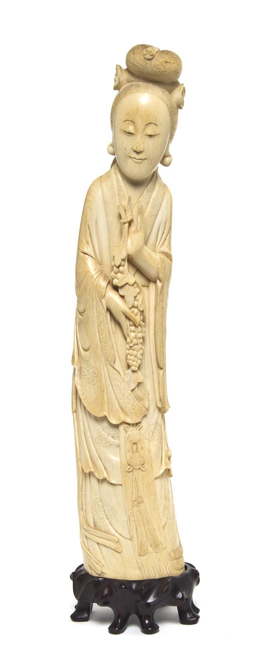 *A Chinese Carved Ivory Figure of a