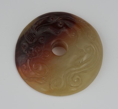 A Chinese Carved Jade Disk With Red
