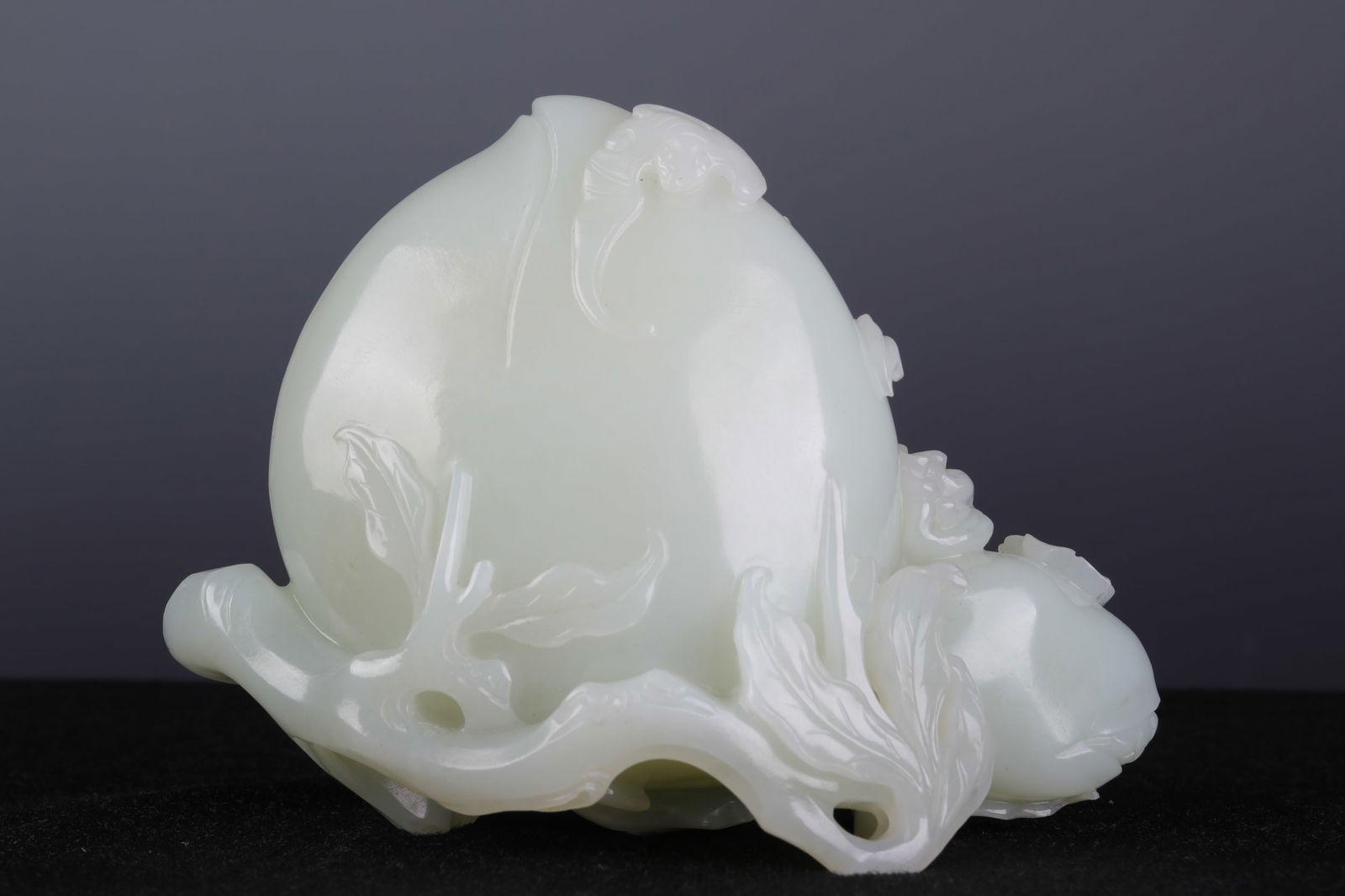 A CHINESE CARVED JADE PEACHES