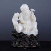 A CHINESE CARVED JADE SEATED F