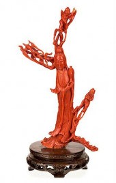 A CHINESE CARVED RED CORAL FIG