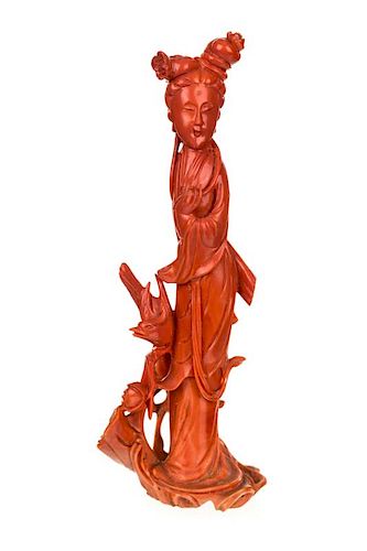 A CHINESE CARVED RED CORAL FIGURE