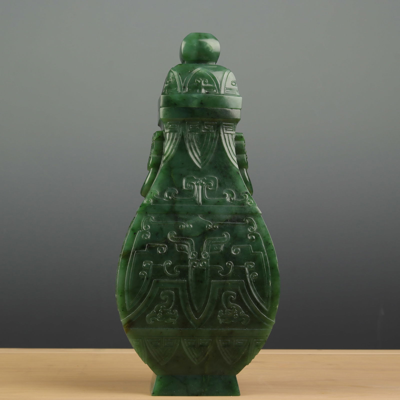 A CHINESE CARVED SPINACH GREEN JADE